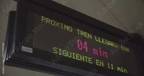 Urban Mobility in a Warming World. Urban commuting sign showing the arrival time of the next train, highlighting the importance of public transportation as a sustainable alternative. Metro.