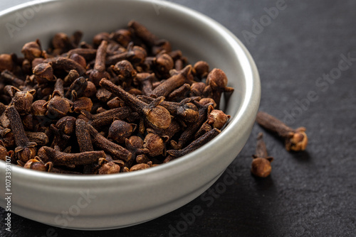 Wallpaper Mural Whole cloves spice in a bowl over black background. Dry clove buds in a gray ceramic bowl macro. Cooking, herbal medicine and spice concept. Torontodigital.ca