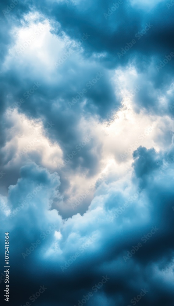Obraz premium A swirling display of dark and light clouds set against a dramatic sky, creating a moody and atmospheric effect.