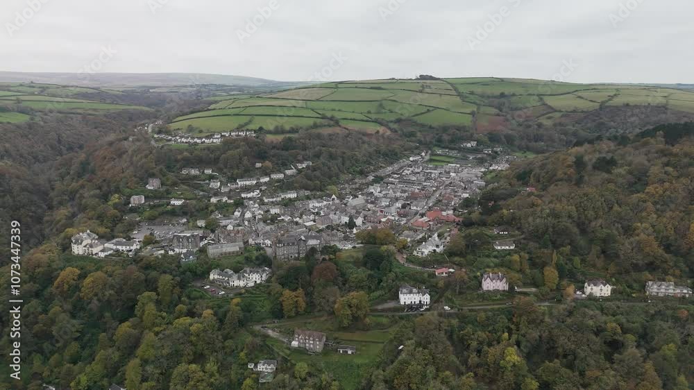 Camera panning over picturesque village nestled in valley Camera panning over picturesque village nestled in valley
