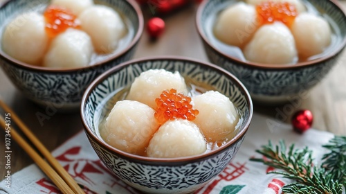 Chinese tangyuan rice dumplings in sweet syrup, presented in small festive bowls photo