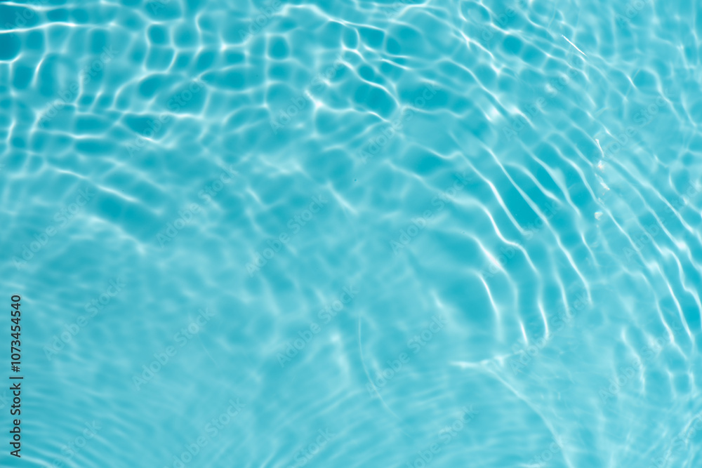 Blue water with ripples on the surface. Defocus blurred transparent blue colored clear calm water surface texture with splashes and bubbles. Water waves with shining pattern texture background. Blue water with ripples on the surface. Defocus blurred transparent blue colored clear calm water surface texture with splashes and bubbles. Water waves with shining pattern texture background.