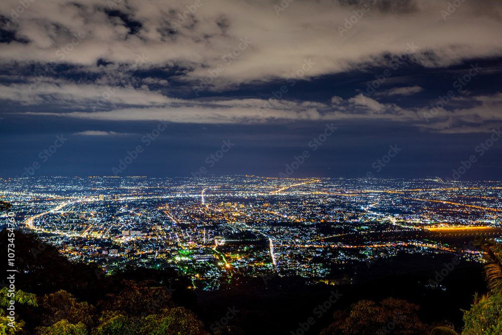 Obraz premium High angle view background from the mountain, showing the lights of apartment buildings, houses, car lights and street lights, the advancement of technology and electricity lighting at night.