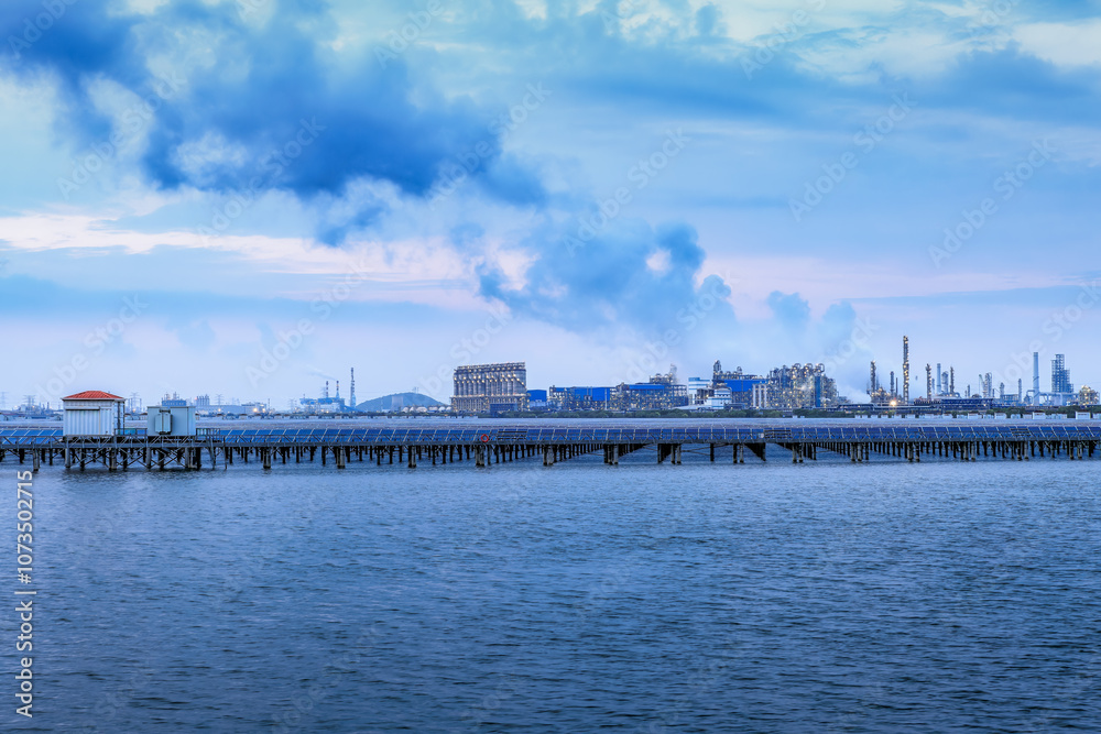 Petrochemical plant industrial equipment and river at sunset. Business Finance and Industry Petrochemical plant industrial equipment and river at sunset. Business Finance and Industry