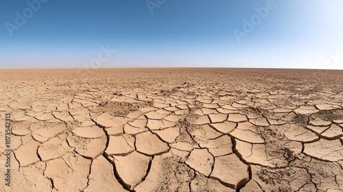 Desolate dry landscape with deep cracks and fissures in the parched cracked earth reflecting the extreme heat and dryness of the environment  This image conveys a sense of a harsh unforgiving photo