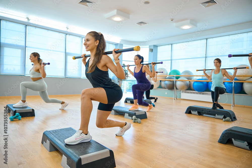 Group fitness class in a spacious hall Group fitness class in a spacious hall