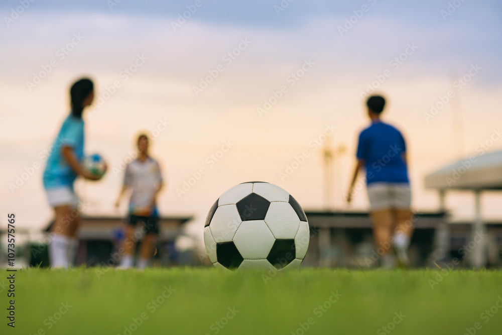 Φωτογραφία Action sport outdoors of kids having fun playing soccer football for exercise in community rural area under the twilight sunset sky