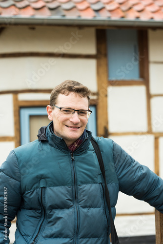 Portrait of a forty year old handsome man with glasses posing at the Belgian countryside