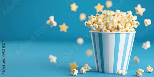 Delicious popcorn in a striped bucket with playful stars scattered around. photo