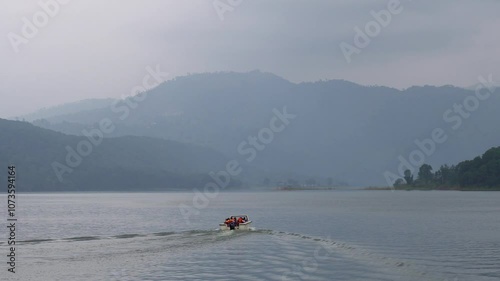 Back view of a speed boat with tourist at Umiam Lake Borapani Meghalaya with blue hills in the background 13 photo