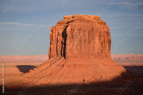 Breathtaking sunset over Merrick Butte in Monument Valley, Arizona. The vibrant colors and unique rock formation create a stunning landscape. Ideal for travel, nature, and southwest USA imagery.