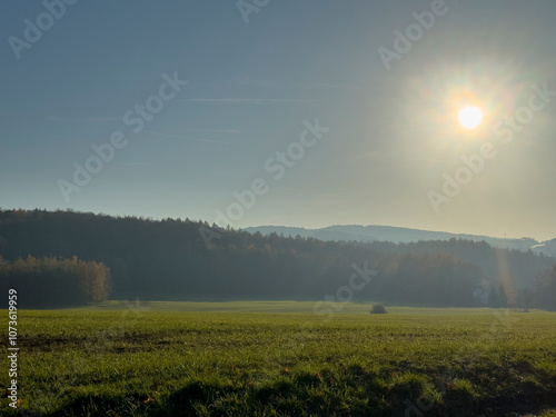 View over the Ore Mountains in foggy morning with sun and blue sky