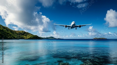 Wallpaper Mural Airplane landing over a tropical island and ocean with blue skies and white clouds. Torontodigital.ca