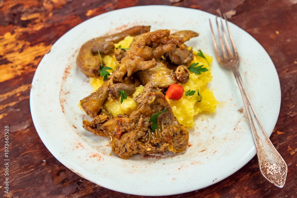 Traditional and rustic Brazilian dish, free-range chicken with polenta. Real food Traditional and rustic Brazilian dish, free-range chicken with polenta. Real food