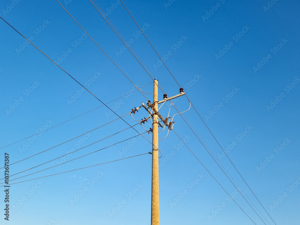 Network of electric cables on electric poles with a clear blue sky in the afternoon Network of electric cables on electric poles with a clear blue sky in the afternoon
