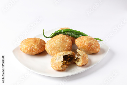 Kachori, green chilly, kachori is a spicy snack from India also called  kachauri and kachodi. Favorite Tea time snacks
served in a ceramic plate photo