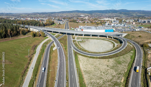 Nowy Trag, Poland. Present end of new Zakopinaka Highway under construction but opened for traffic. Exit rams to old road to Zakopane and Nowy Targ town center. Aerial view. State in October 2024