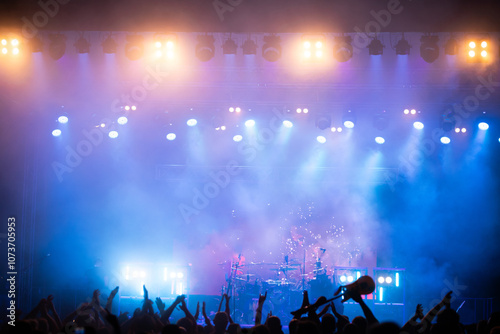 Crowd at concert and blurred stage lights.