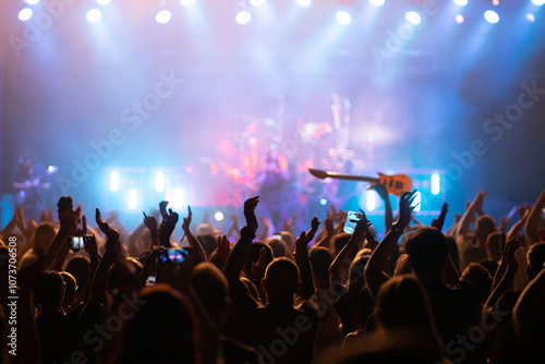 Crowd at concert and blurred stage lights.