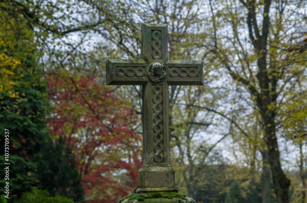 Celtic cross standing in a cemetery during autumn Celtic cross standing in a cemetery during autumn