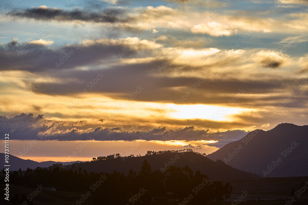 The sun dips below the hills of Chinchero, casting a golden embrace over this sacred land.Nature and history blend seamlessly as the day ends, reminding us of the timeless beauty of Peru’s Andes. The sun dips below the hills of Chinchero, casting a golden embrace over this sacred land.Nature and history blend seamlessly as the day ends, reminding us of the timeless beauty of Peru’s Andes.