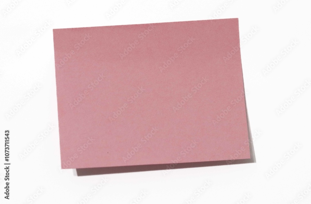 Fototapeta premium Blank Pink Sticky Note on White Background, Representing Space for Messages, Reminders, or Creative Thoughts in Minimalist Design