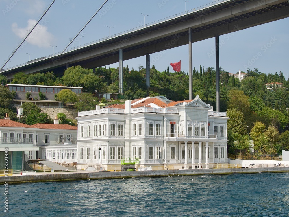 Beautiful white palace along Bosporus Strait under First Bridge in Istanbul, Turkey