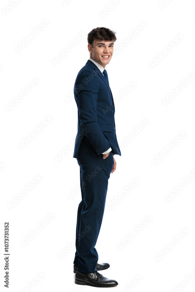 side view of happy young businessman standing in line and smiling side view of happy young businessman standing in line and smiling