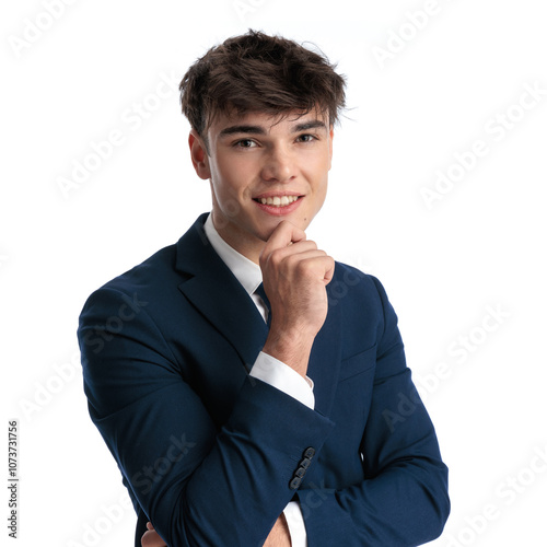 thoughtful young man in navy blue suit folding arms and thinking