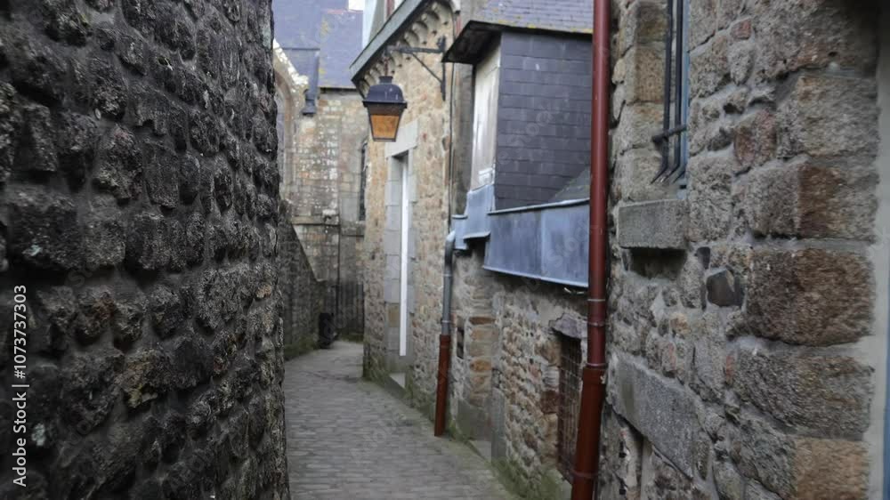 A walk through the narrow, charming streets within Mont-Saint-Michel, France, featuring historic buildings and a unique medieval atmosphere. A walk through the narrow, charming streets within Mont-Saint-Michel, France, featuring historic buildings and a unique medieval atmosphere.