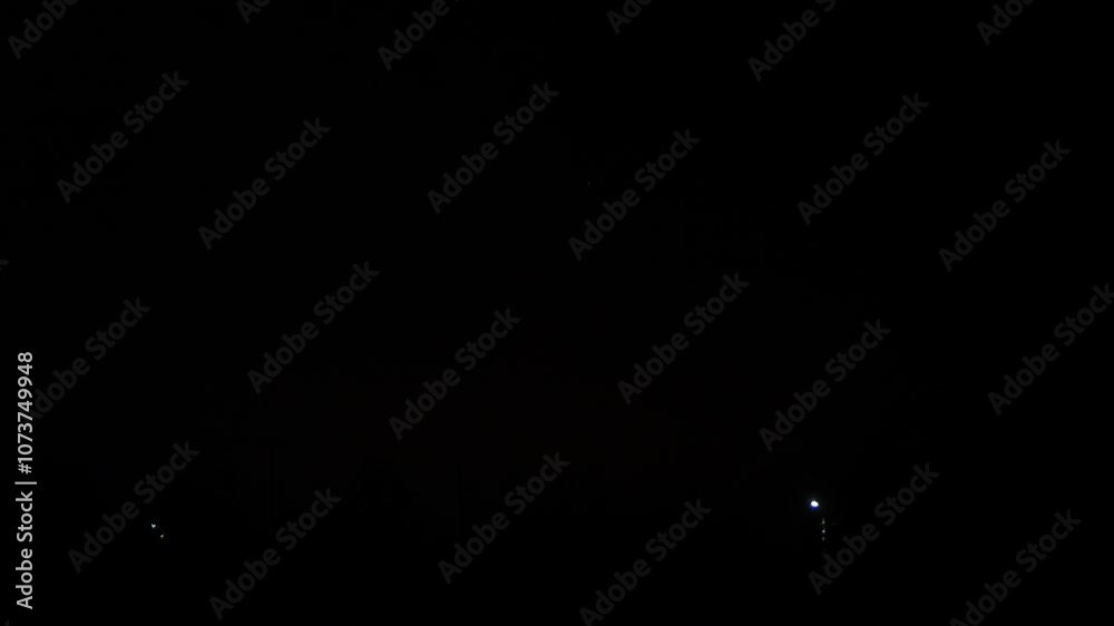 gold red green sparks scatter fireworks on the black night sky over the city. General plan