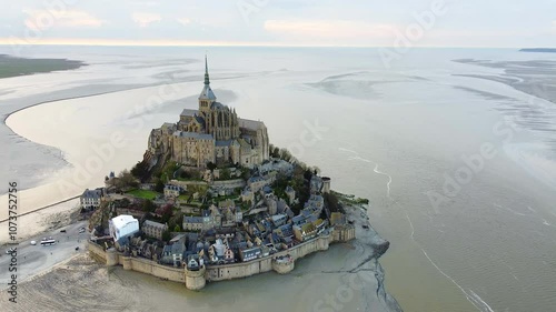 Aerial view of the iconic Mont Saint-Michel, a historic town with Gothic architecture located on a small island in Normandy, France. 