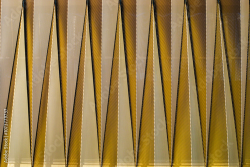 ARCHITECTURAL GEOMETRY, GEMOETRIC DECOMPOSITION, TRIANGLES, METAL, METAL REFLECTIONS, YELLOWS, ORANGES, MODERN ARCHITECTURE,  photo