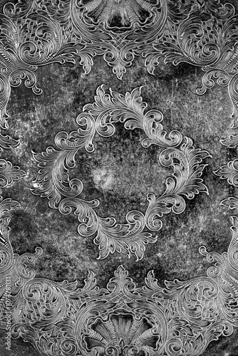 Engraving pattern background on an antique silver plate pewter tray.  Antique vintage metalwork concept.