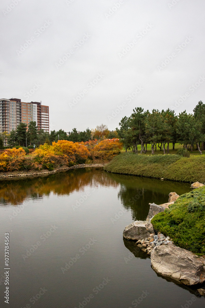 multi-storey modern house in autumn park, reflection in water, architecture, lake, yellow leaves of trees multi-storey modern house in autumn park, reflection in water, architecture, lake, yellow leaves of trees