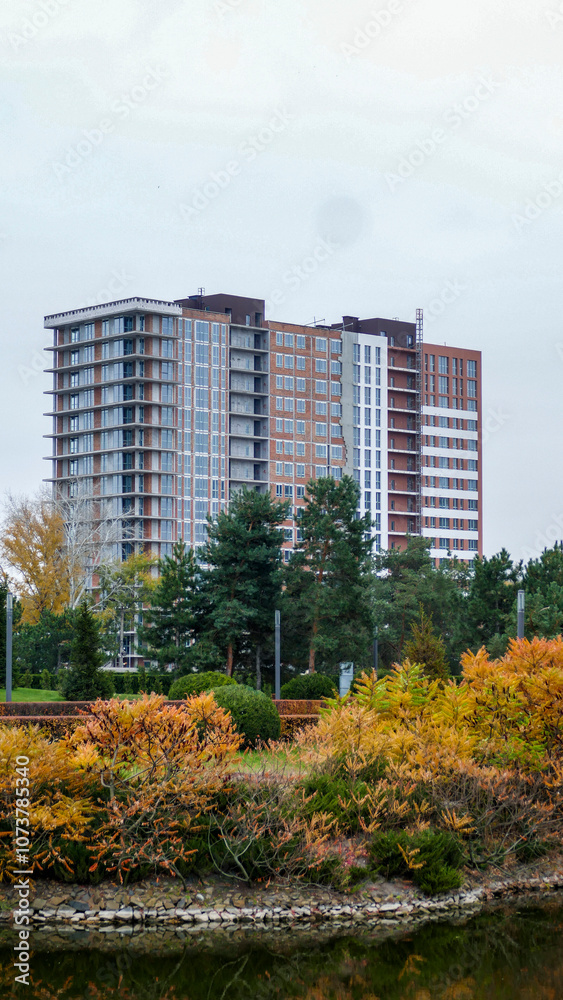 multi-storey modern house in autumn park, reflection in water, architecture, lake, yellow leaves of trees multi-storey modern house in autumn park, reflection in water, architecture, lake, yellow leaves of trees