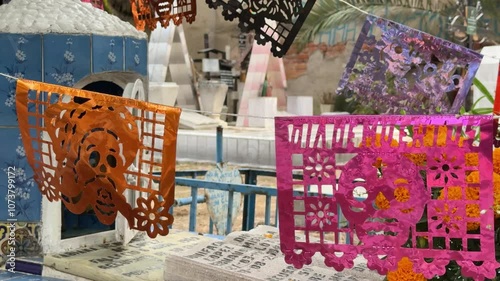 Traditional handmade papel picado waving in wind in cemetery, close up