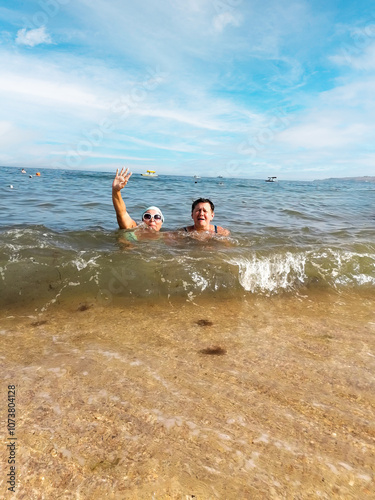 Carefree Summer Moments: Two Women Swimming in the Sea.