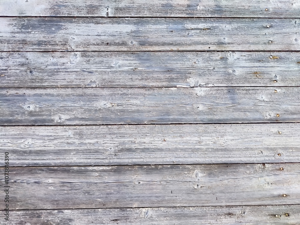 Weathered wooden planks arranged in a horizontal pattern with a rustic gray finish Weathered wooden planks arranged in a horizontal pattern with a rustic gray finish