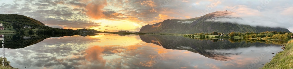 Panoramic view of Norway's Lofoten Islands under the midnight sun. Golden light illuminates mountains, coastlines, and calm waters, showcasing the stunning beauty of the Arctic summer landscape. Panoramic view of Norway's Lofoten Islands under the midnight sun. Golden light illuminates mountains, coastlines, and calm waters, showcasing the stunning beauty of the Arctic summer landscape.