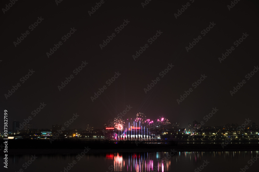 Fototapeta premium Colorful fireworks celebration and the city night light .