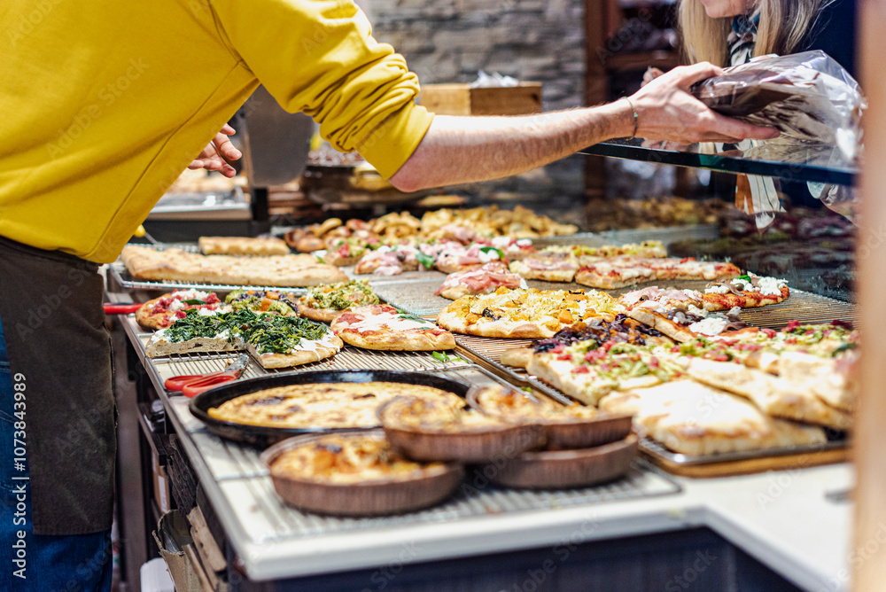Pizza by the slice in an italian bakery. Pizza by the slice in an italian bakery.