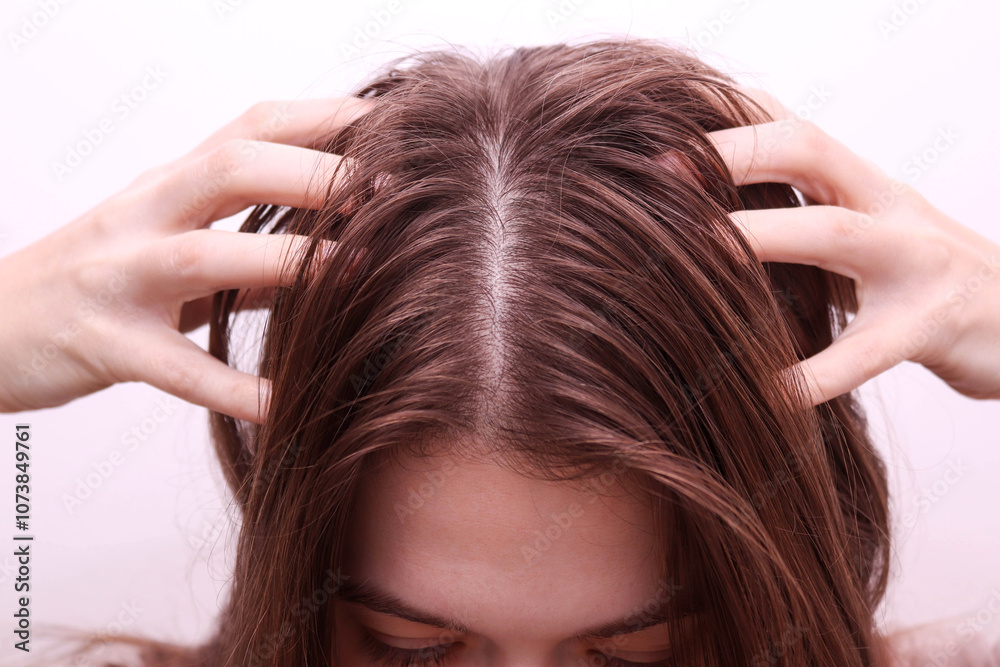 Fototapeta premium Woman touching her dirty and greasy hair. Hair problem concept.