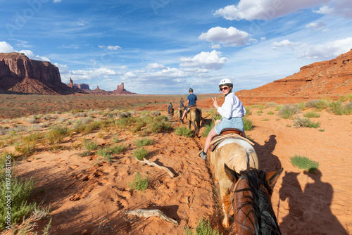 Monument Valley Horseback Riding First person view from horse with sunset sky over the Three Sisters photo