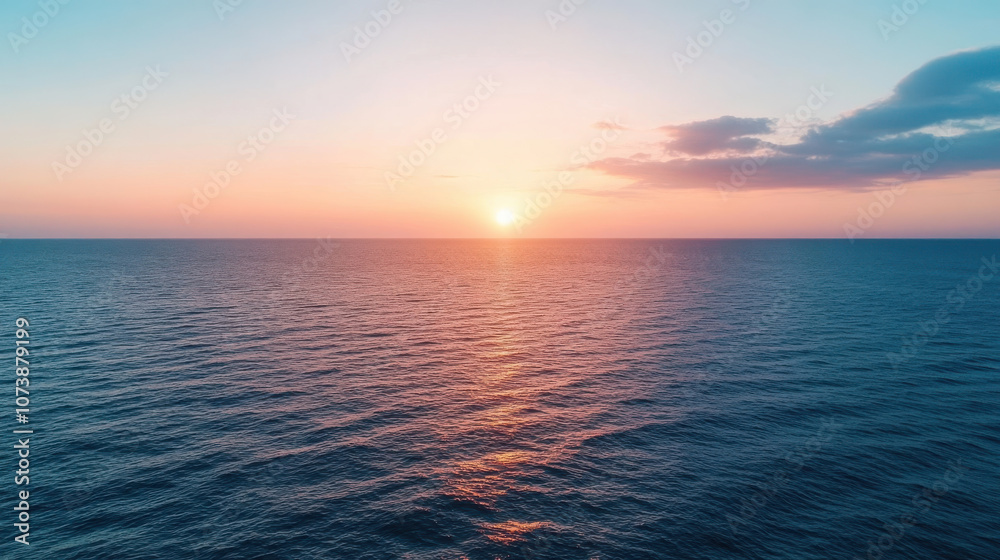 Sunset over calm ocean waters with warm colors reflecting on waves Sunset over calm ocean waters with warm colors reflecting on waves
