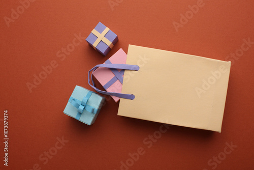 Paper crafts shopping bags shirts and gifts on color background, discount shopping and shopping concept. Black Friday