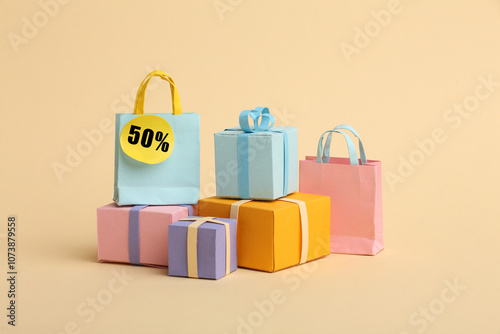 Paper crafts shopping bags shirts and gifts on color background, discount shopping and shopping concept. Black Friday