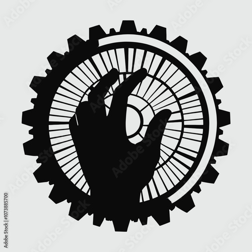 a black and white silhouette of a hand pressing a button on a gear.