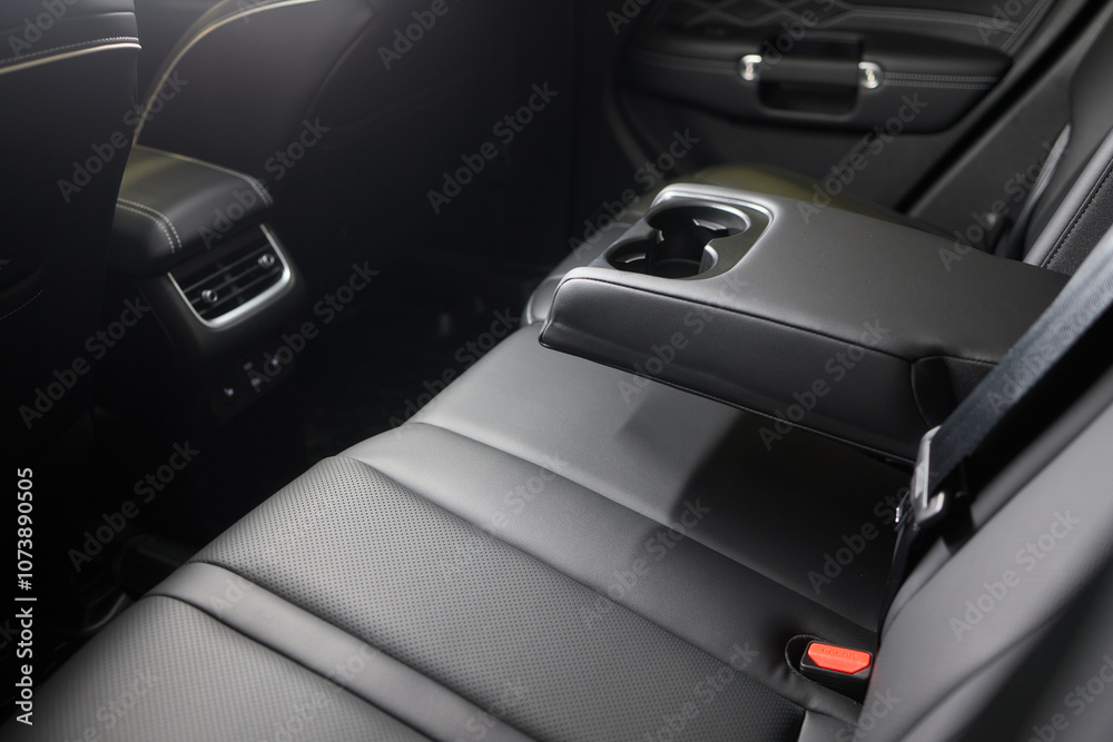 Obraz premium Vehicle armrest with cup holder, beige design, for luxury cars