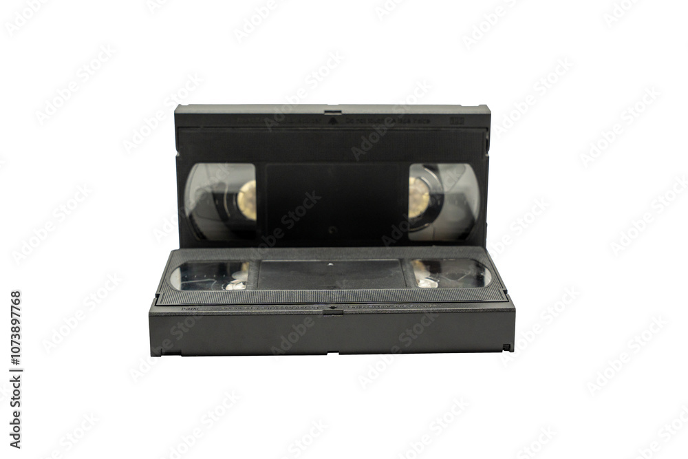 Obraz premium A black VHS tape is laying on a white background. The tape is empty and has no visible content